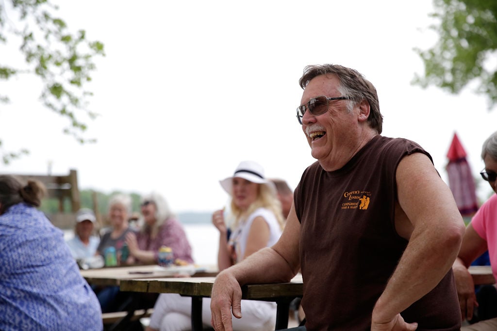 Mike Cooper laughs at a joke told during his roast and retirement party